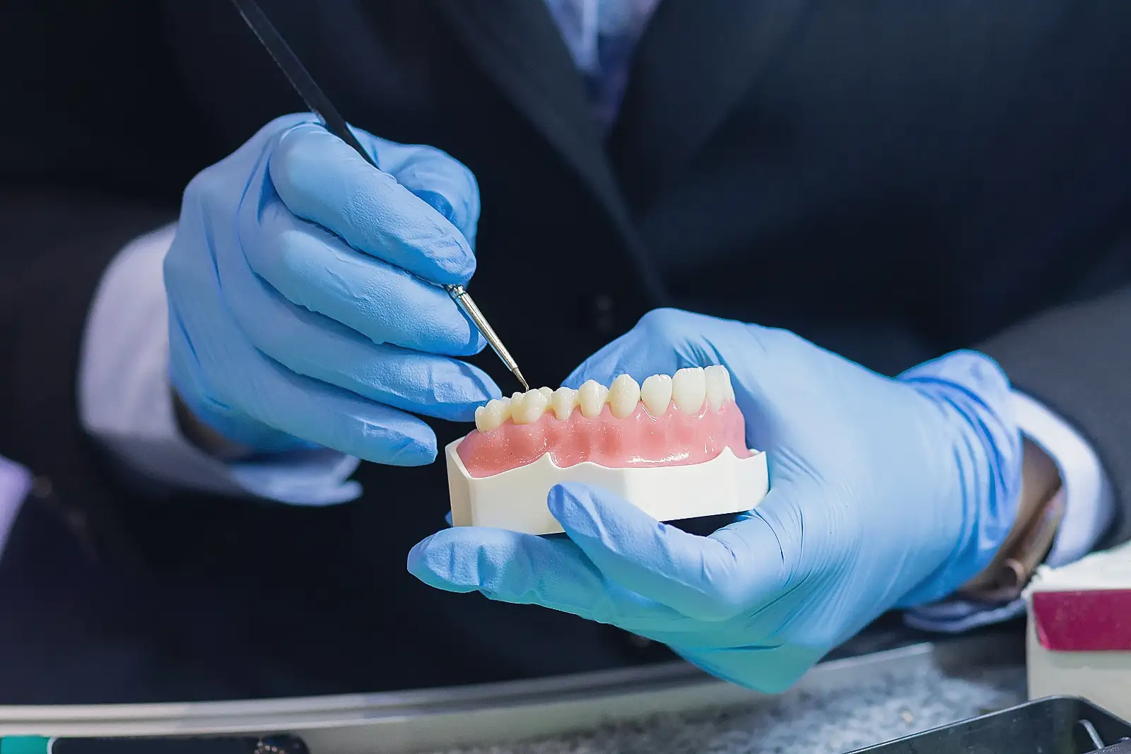 Denturist working on dentures